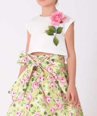 ecru blouse with a 3D rose and green floral skirt