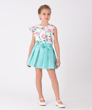 ecru blouse with flower prints and blue skirt