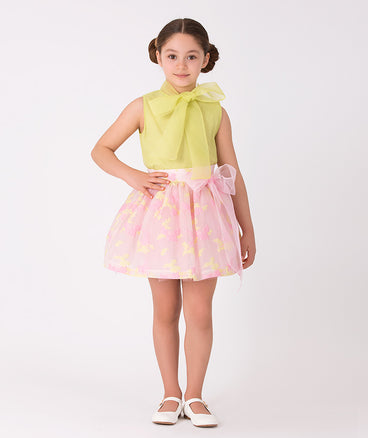 green bow blouse and pastel pink skirt