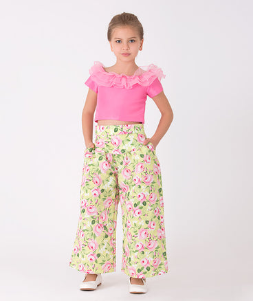 pink ruffled blouse and green floral pants