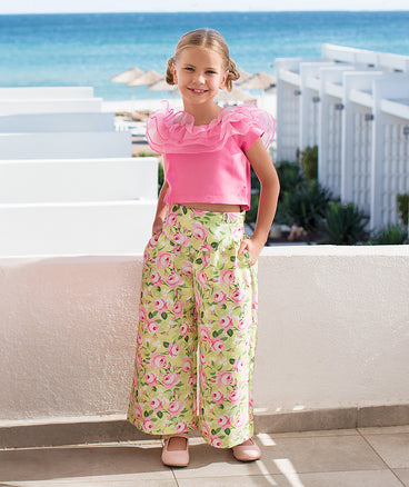 pink ruffled blouse and green floral pants