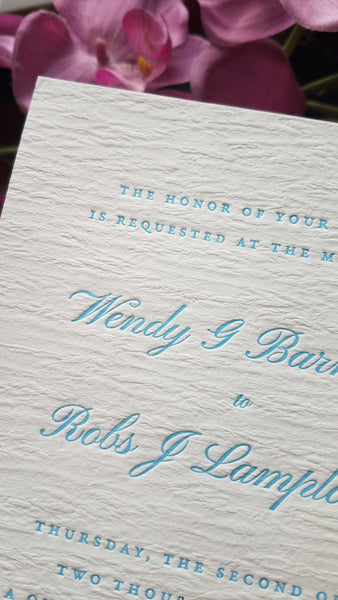 Letterpress wedding invitation with aqua ink on white Ruche paper by inviting in Austin Texas.