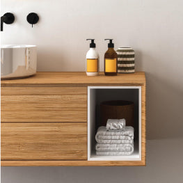 A bathroom sink with pull out drawers and a shelf