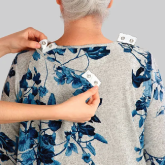 The back of an elderly woman with adaptive clothing on