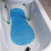 A bath mat in the bottom of a tub
