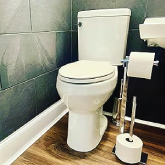 An elevated toilet in a bathroom