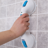 A grab bar being held against a wall
