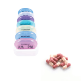 A seven day color coded pill organizer next to pills