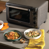 A smart oven next to bowls of food
