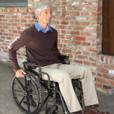 An elderly man in a wheelchair