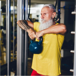 A senior man using a kettlebell to exercise