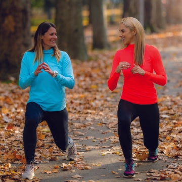 Two women doing lunges which can aggravate hip bursitis