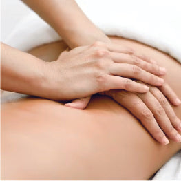 Close up of a massage therapist's hands massaging hip bursitis