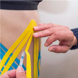 Kinesiology tape being applied to hip bursitis