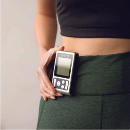 A TENS unit clipped to a woman’s hip