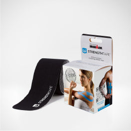 Black kinesiology tape next to its packaging