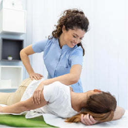 A physical therapist helping a patient with a hip flexor strain