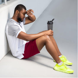 A man drinking water recovering from exercise
