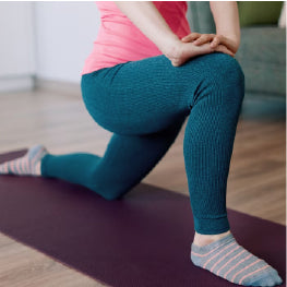 A person doing a hip flexor stretch on a yoga mat