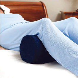 A woman using a pillow below her knees