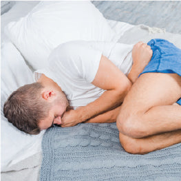 A man laying on his side with hip pain
