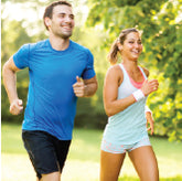 A man and woman running outside