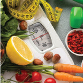 A scale surrounded by fruits and vegetables