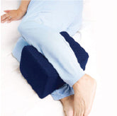 A woman's legs with a knee pillow between her calves