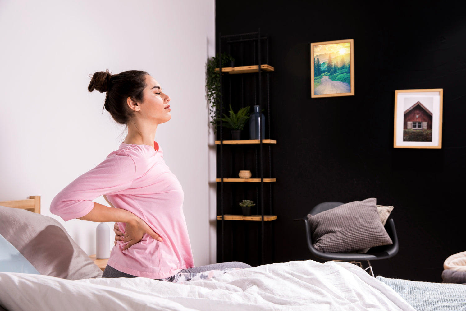 A woman sitting in bed with Piriformis Syndrome pain