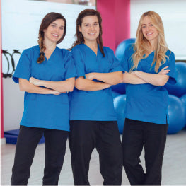 Three physical therapists smiling with their arms crossed