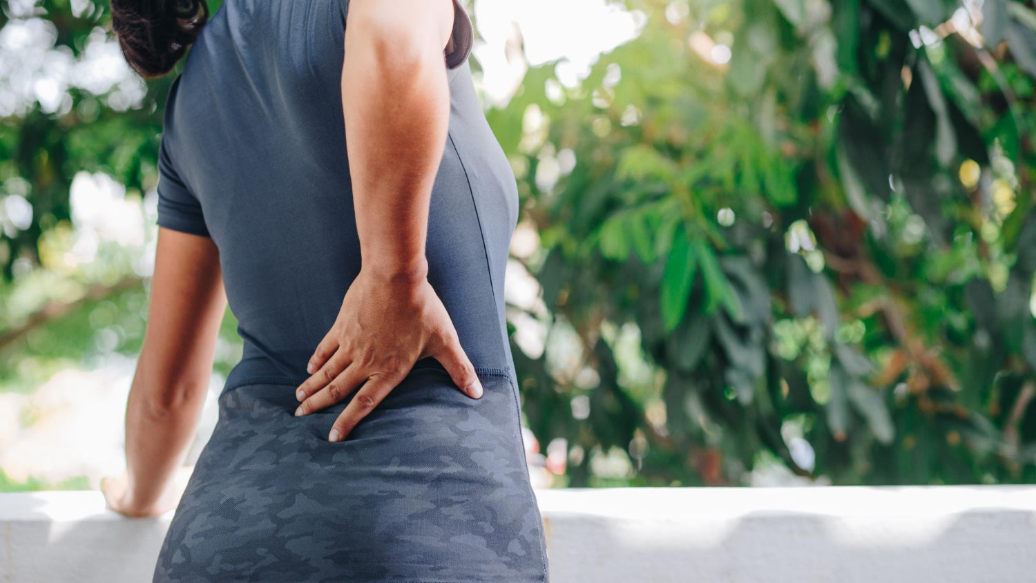 A woman holding her hip in pain