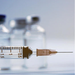 A needle with vials in the background