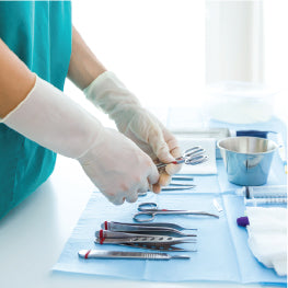 A surgeon laying out various tools in preparation for sugery