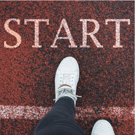 A person’s foot in front of the word “start”