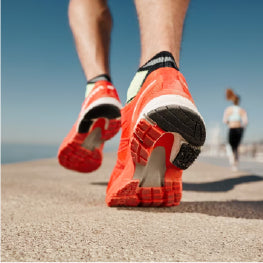 A close up of a person’s running shoes