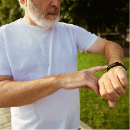 An elderly man checking his fitness tracker