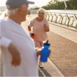 An elderly couple running