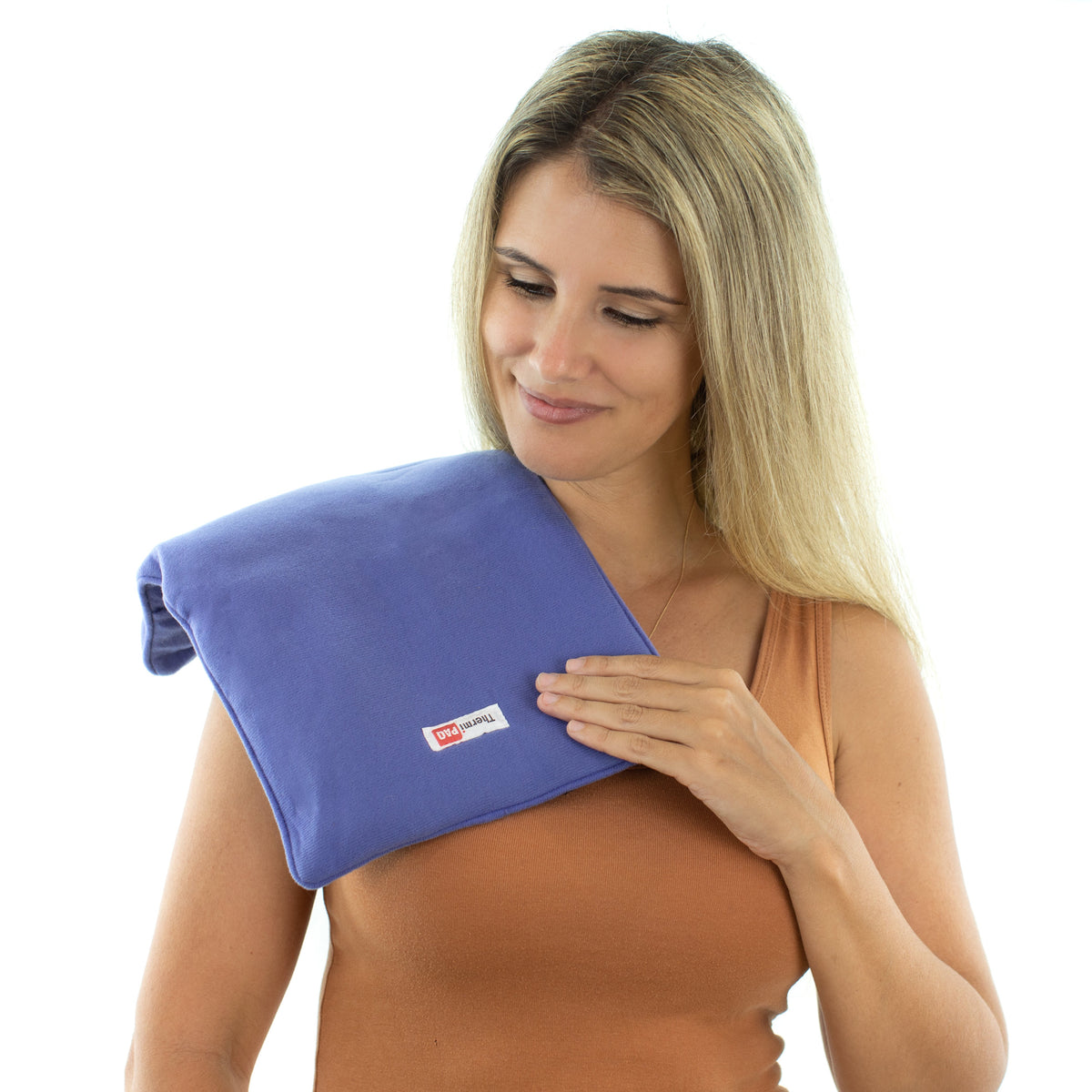 A smiling woman with the larger ThermiPaq Hot/Cold Pain Relief Wrap over her shoulder
