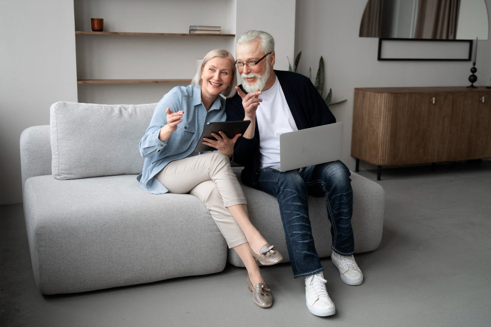 An elderly couple sitting on a couch