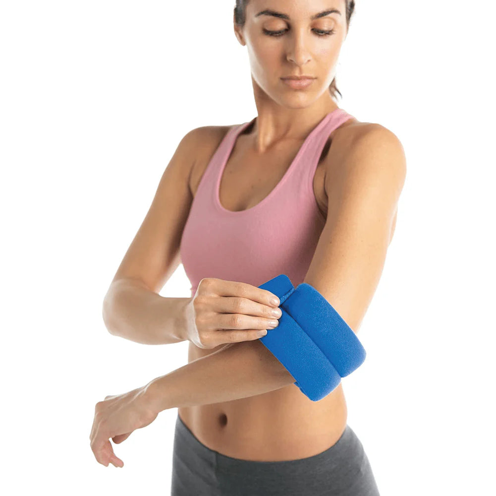 A woman placing a hot/cold wrap on her elbow