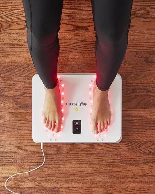 A view of feet on the Bright Health Red Light Therapy Foot Pain Relief Device