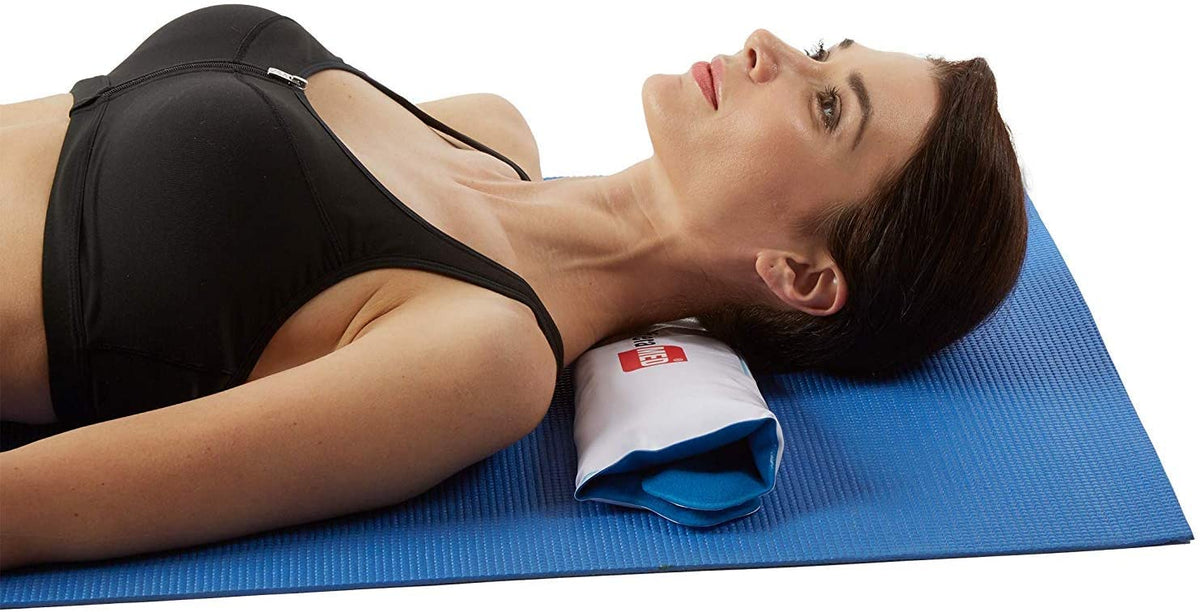 A woman lying on her back using the TheraMed Reusable Cold Pack for her neck.