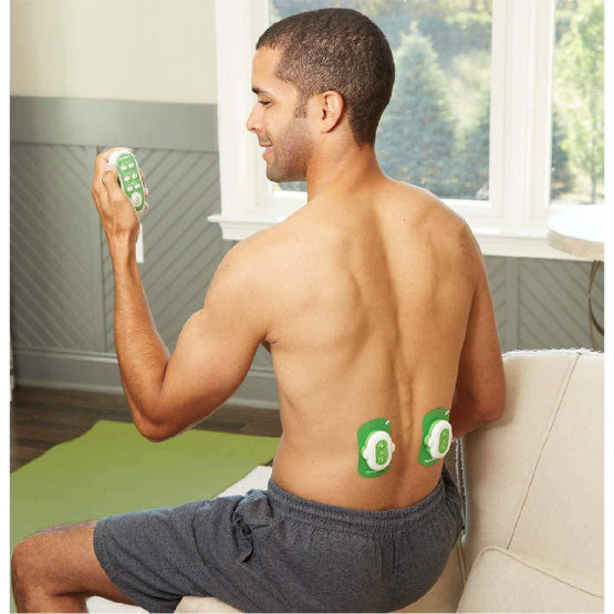 A shirtless man using the AccuRelief Wireless TENS Unit on his lower back