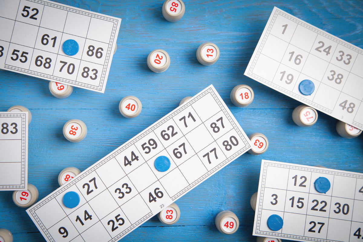 Various bingo mats on a blue surface
