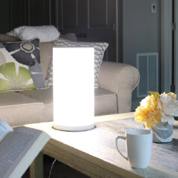 The 14” Bright Health light therapy lamp on a coffee table
