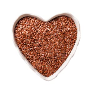 Grains in a heart-shaped bowl on a white background