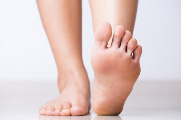 A person’s feet with one pointed up