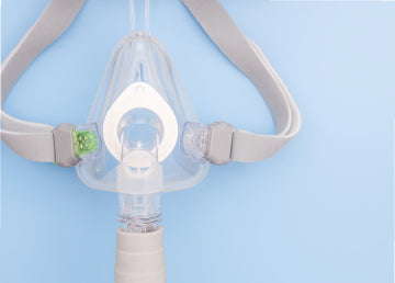 A CPAP mask on a blue surface