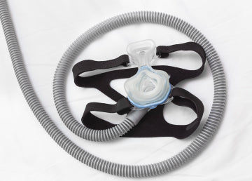 A CPAP mask with a hose laid out