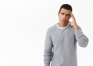 A man holding his head from being dizzy